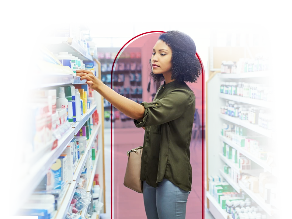 Woman looking at over-the-counter drugs in a pharmacy. 