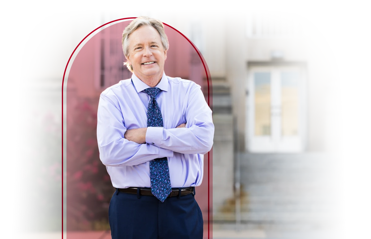Male in shirt and tie posing in front of a court house.