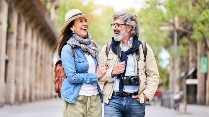 Retired couple enjoying a sightseeing walk on street in spring.