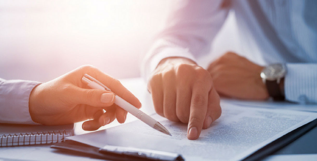 hands pointing at paper