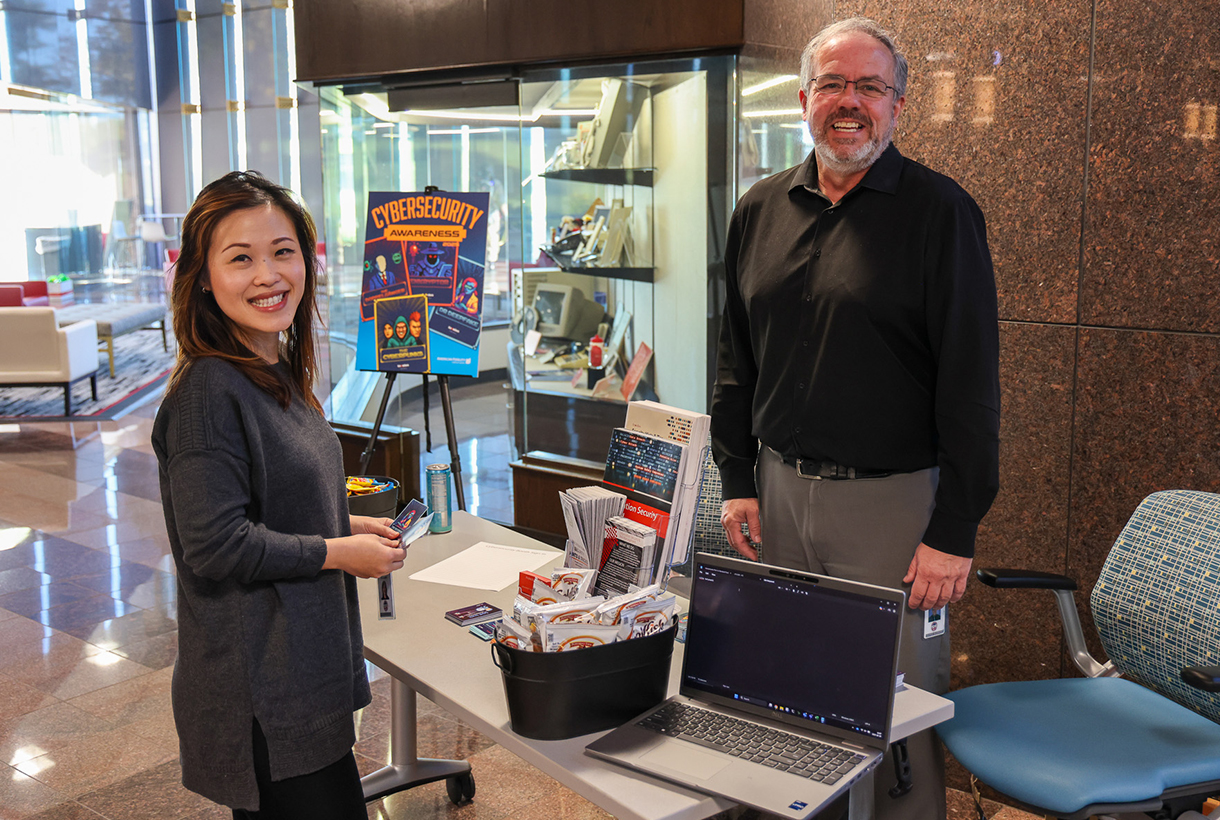 Colleagues meet and discuss Cybersecurity Awareness Month!