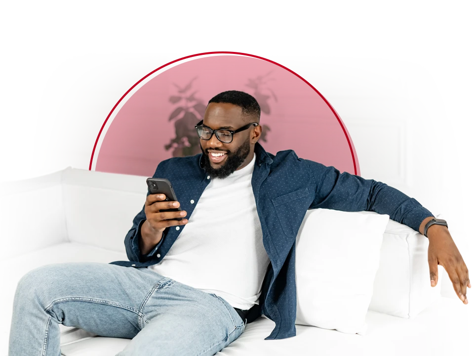 Young man on couch looking at his phone.