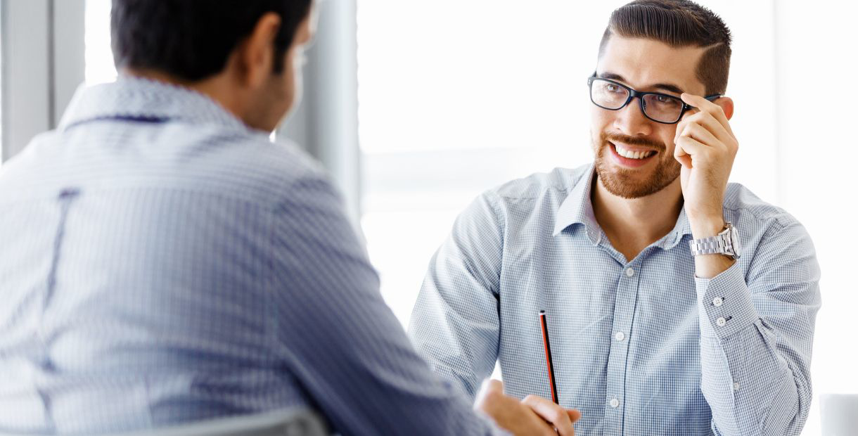 Two men speaking with each other.