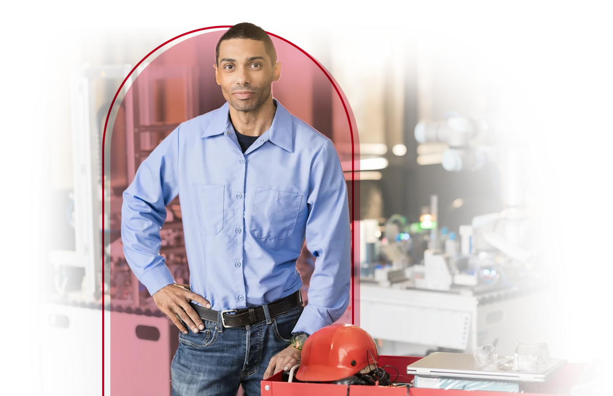 Male worker posing in front of his work area.