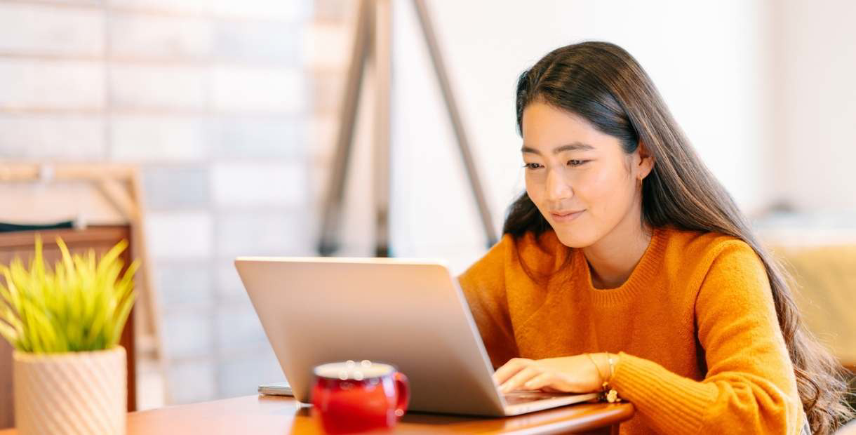 A woman looking over her HSA contributions on her laptop.