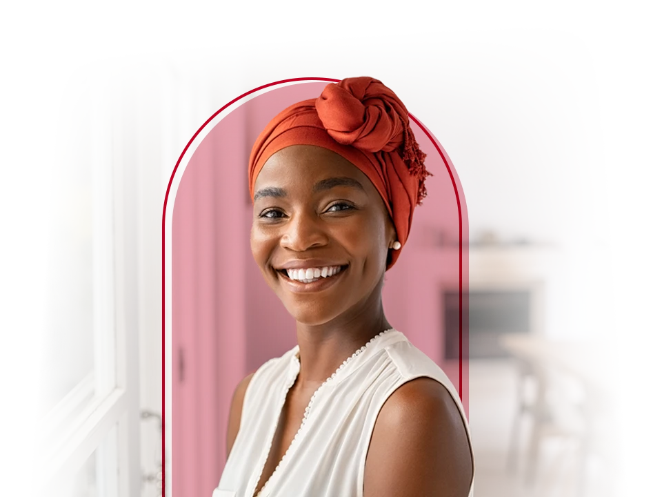Lady smiling with a pretty head wrap on her head.