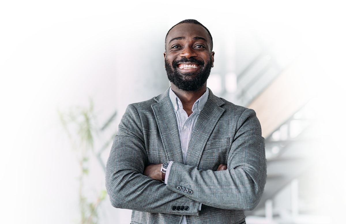 Confident administrator with crossed arms, smiling at the camera.