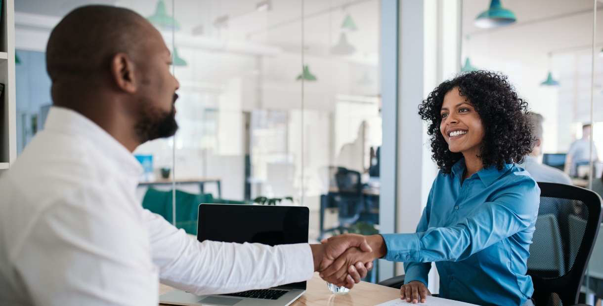Man and woman shaking hands.