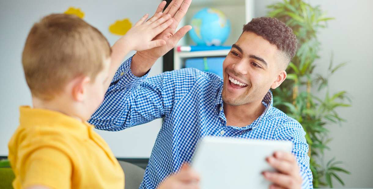 Man and boy high-fiving.