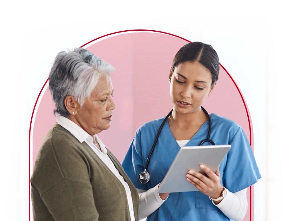 Doctor looking at a tablet with a patient.
