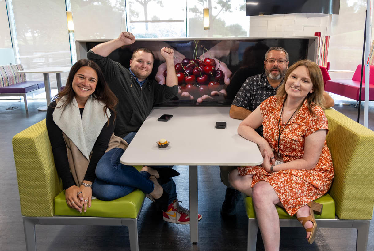 Colleagues sitting at a table enjoying American Fidelity's grill. 