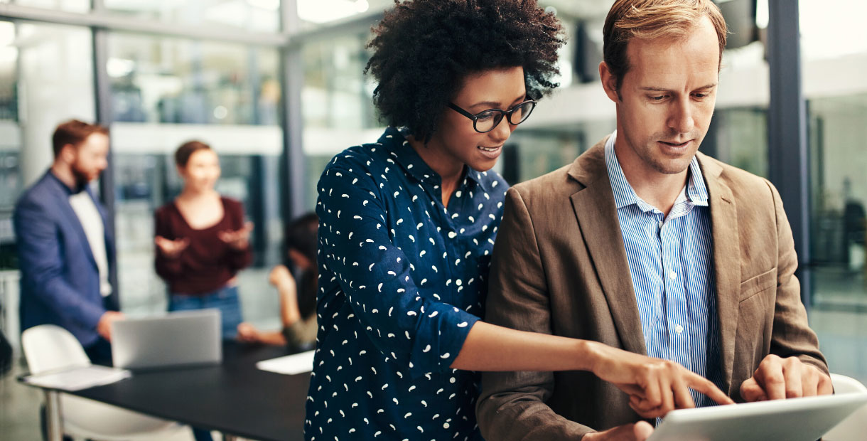 A man and woman at the office going over enrollment questions.