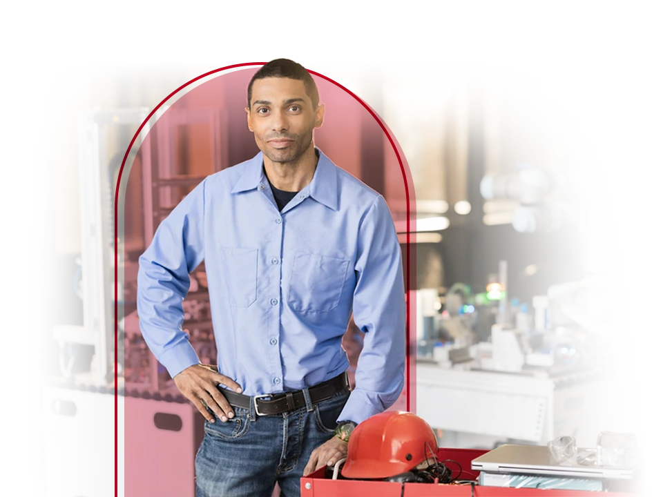 Male worker posing in front of his work area.