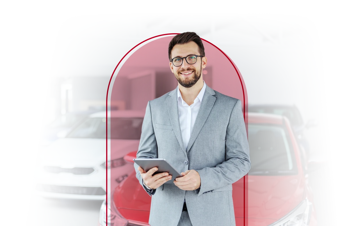 Auto salesperson in a showroom with an iPad.