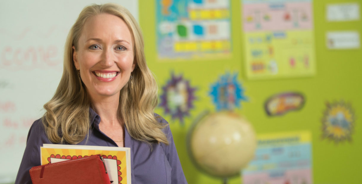 Teacher smiling in a classroom.