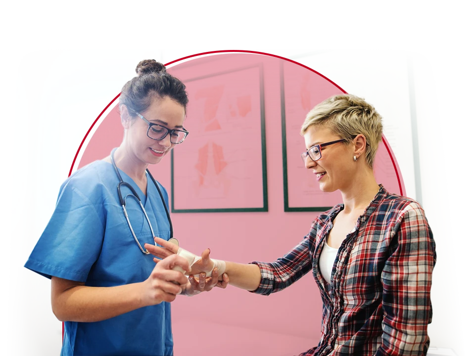 Doctor looking at a patient's hand.