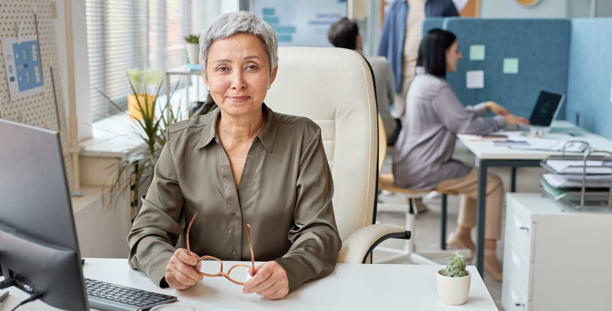 HR manager sitting at a desk in an office.