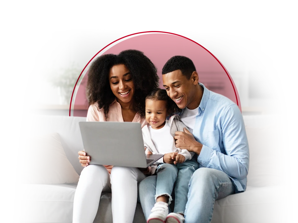 Family of three looking at a laptop.